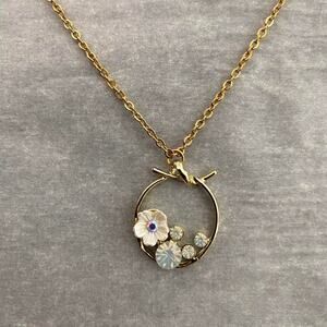 Gold tone flower and gemstone pendant necklace